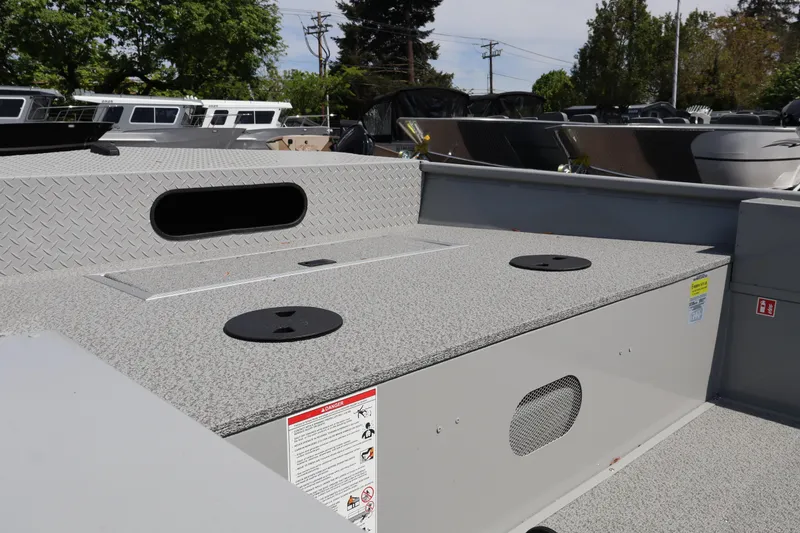 Slide: The Image of 2026 Smoker Craft Sportsman 1866 boat interior with storage compartments and textured flooring. - 8