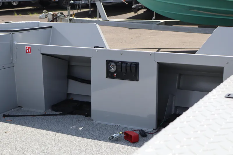Slide: The Image of 2026 Smoker Craft Sportsman 1866 boat interior with control panel and storage compartments. - 9