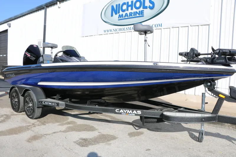 Slide: The Image of 2027 Caymas 201 Pro boat in blue, displayed at Nichols Marine dealership. - 4