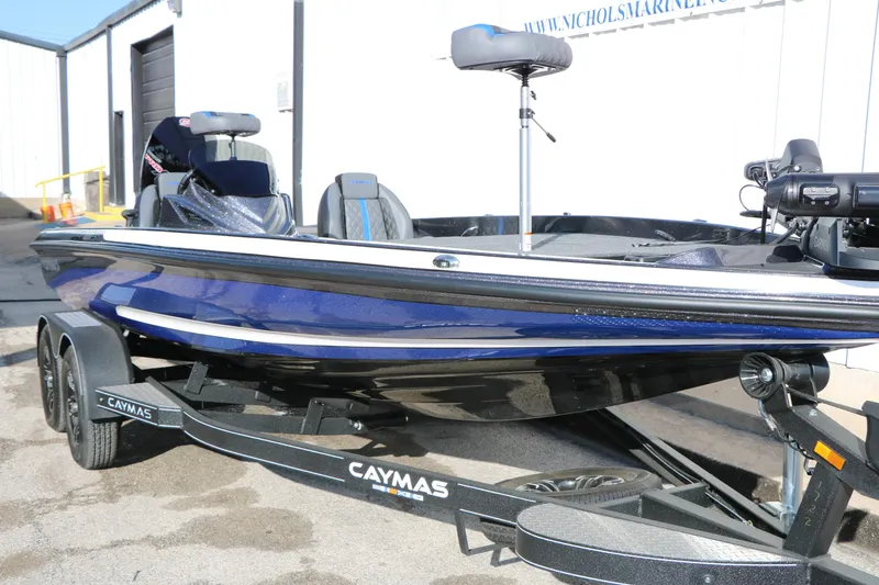 Slide: The Image of 2027 Caymas 201 Pro boat in blue on a trailer, parked outdoors. - 5