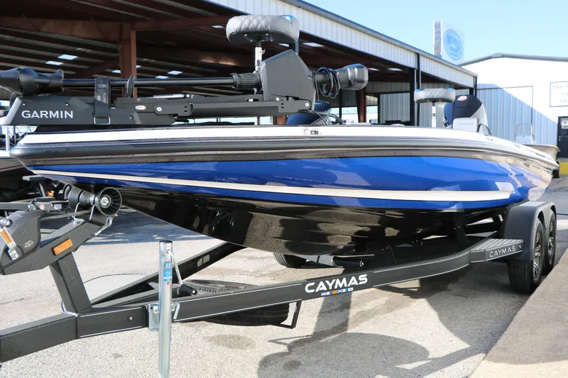 Slide: The Image of 2027 Caymas 201 Pro boat in blue on a trailer, featuring Garmin equipment. - 6