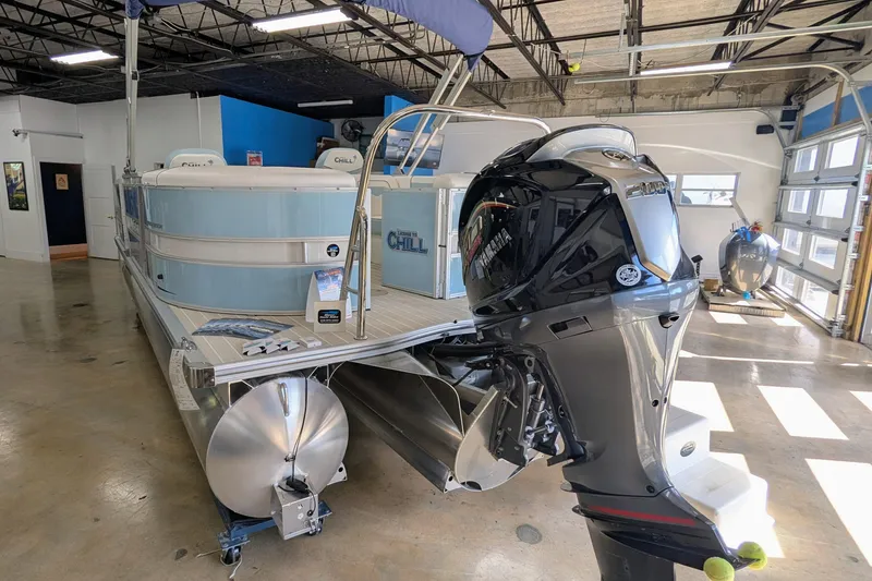 Slide: The Image of 2026 Trifecta CS 22RF pontoon boat with Yamaha outboard motor in showroom. - 10