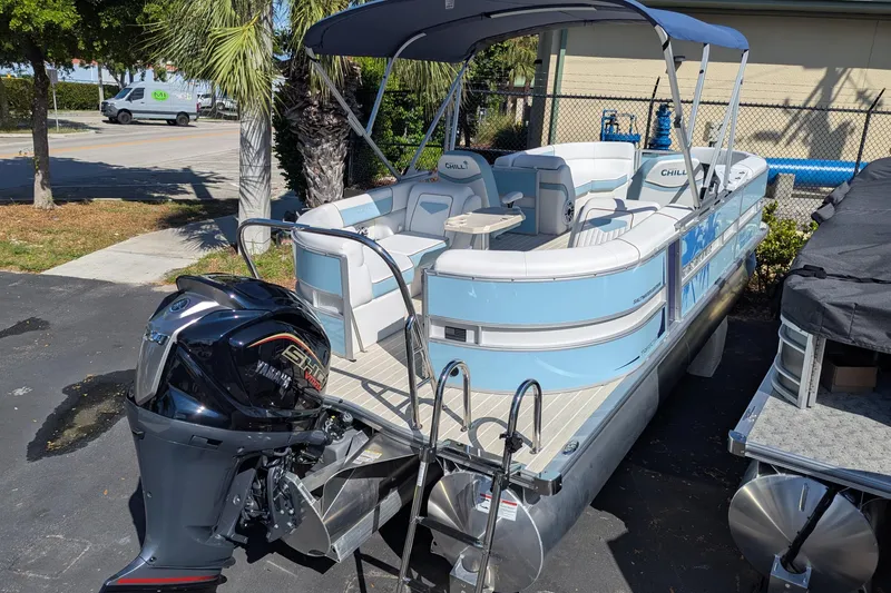 Slide: The Image of 2026 Trifecta CS 22RF pontoon boat with Yamaha outboard motor, parked outdoors. - 11