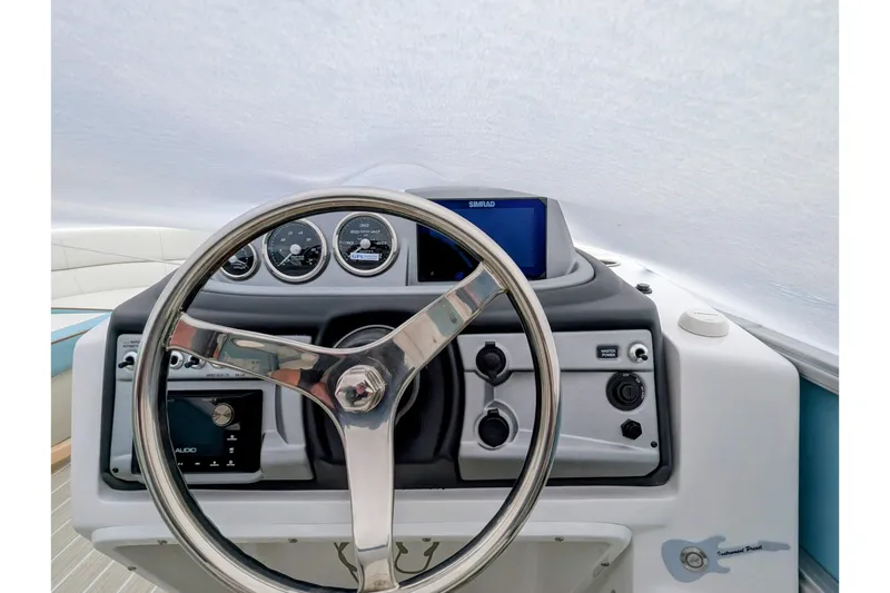 Slide: The Image of Steering console of 2026 Trifecta CS 22RF boat with gauges and controls. - 12