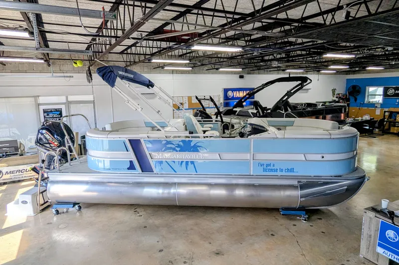 Slide: The Image of 2026 Trifecta CS 22RF pontoon boat in showroom, featuring "Margaritaville" theme and Yamaha engine. - 3