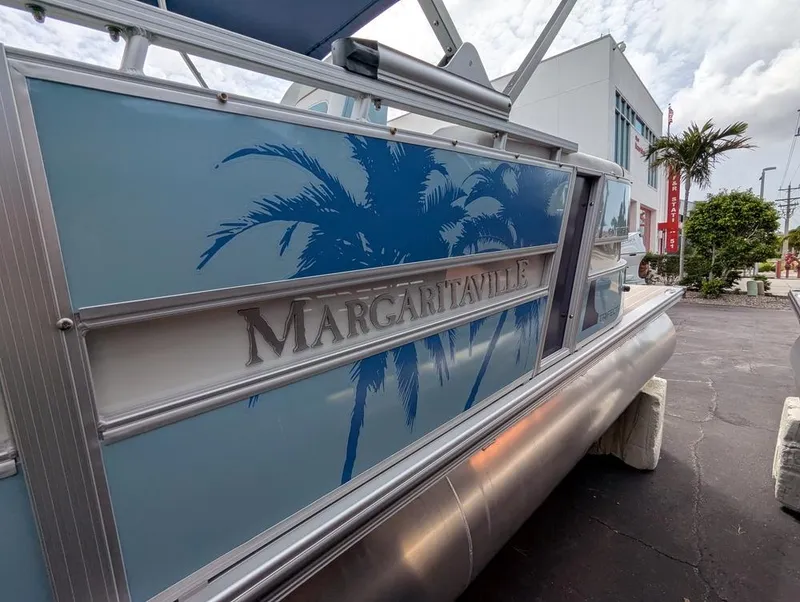 Slide: The Image of 2026 Trifecta CS 22RF boat with Margaritaville branding and palm tree design. - 6