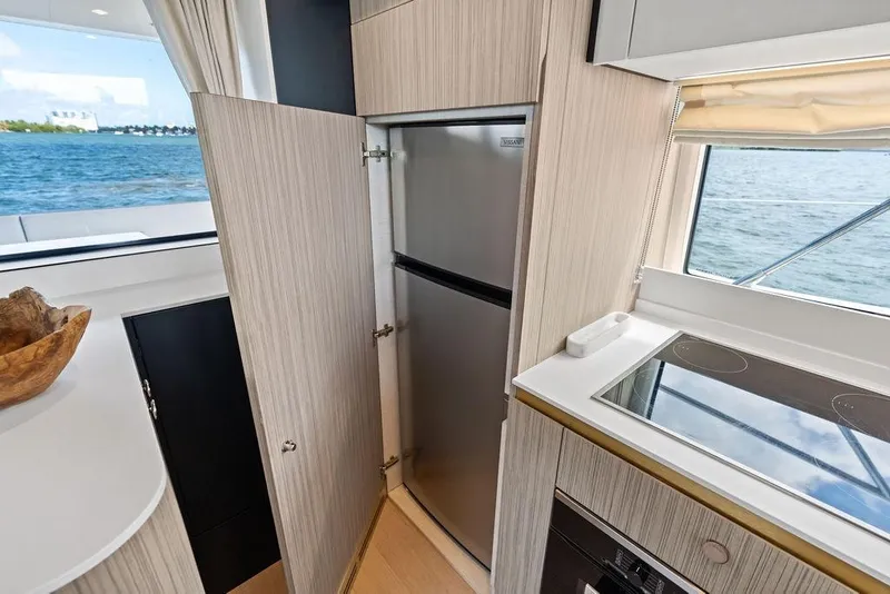 Slide: The Image of Modern Azimut yacht kitchen interior with stainless steel fridge and ocean view, 2019 model. - 18