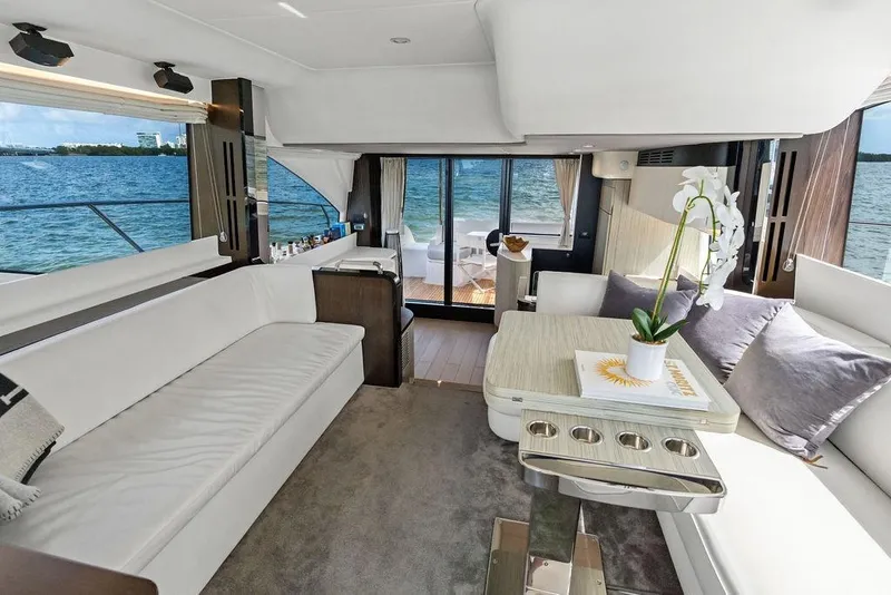 Slide: The Image of Luxurious 2019 Azimut yacht interior with elegant seating, table, and ocean view. - 20