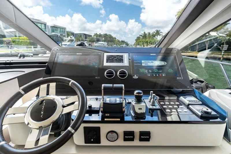 Slide: The Image of Cockpit of a 2019 Azimut yacht with advanced navigation controls and steering wheel. - 26