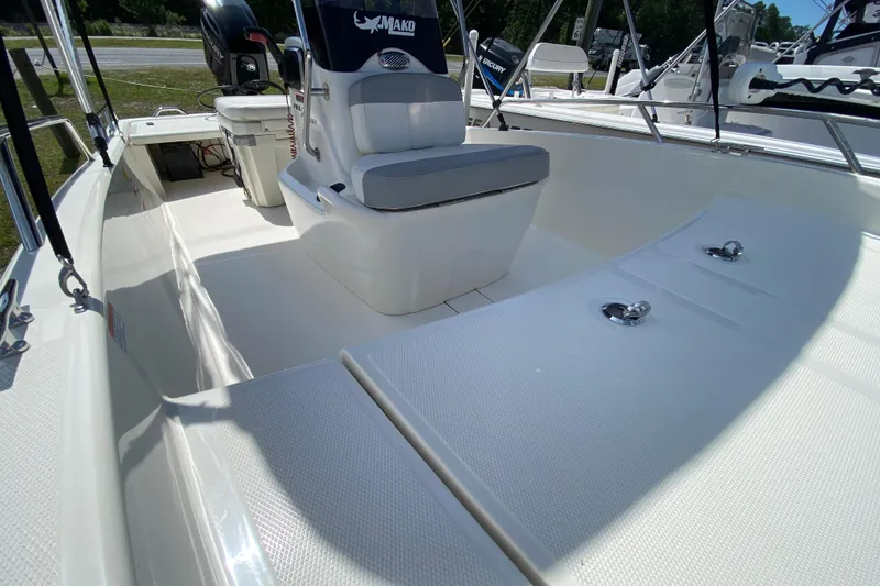 Slide: The Image of 2021 Mako Pro Skiff 15 CC boat interior with seating and storage compartments. - 11
