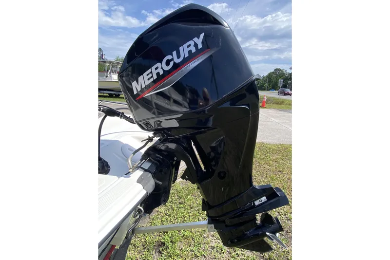 Slide: The Image of 2021 Mako Pro Skiff 15 CC with Mercury outboard motor, parked outdoors. - 4
