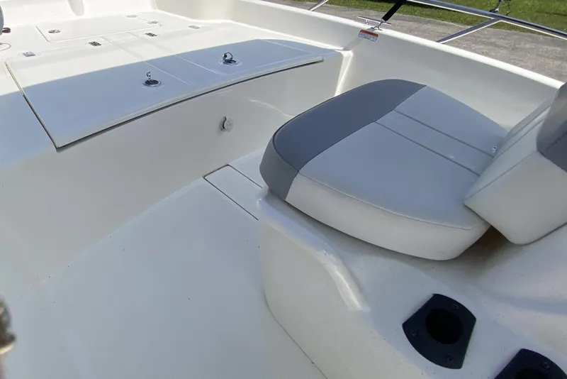 Slide: The Image of 2021 Mako Pro Skiff 15 CC interior with seating and storage compartments. - 7