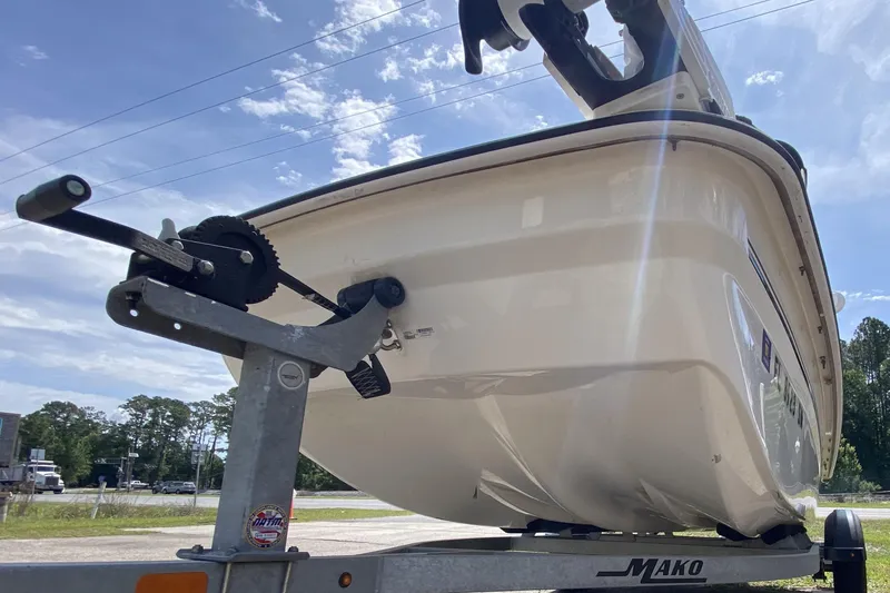 Slide: The Image of 2021 Mako Pro Skiff 15 CC boat on trailer under clear blue sky. - 9