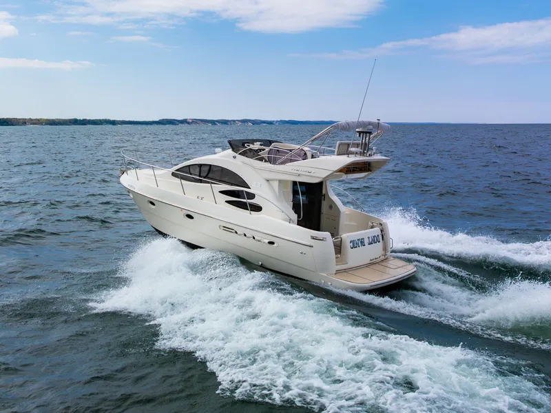 Slide: The Image of 2004 Azimut 39 Flybridge yacht cruising on open water. - 12