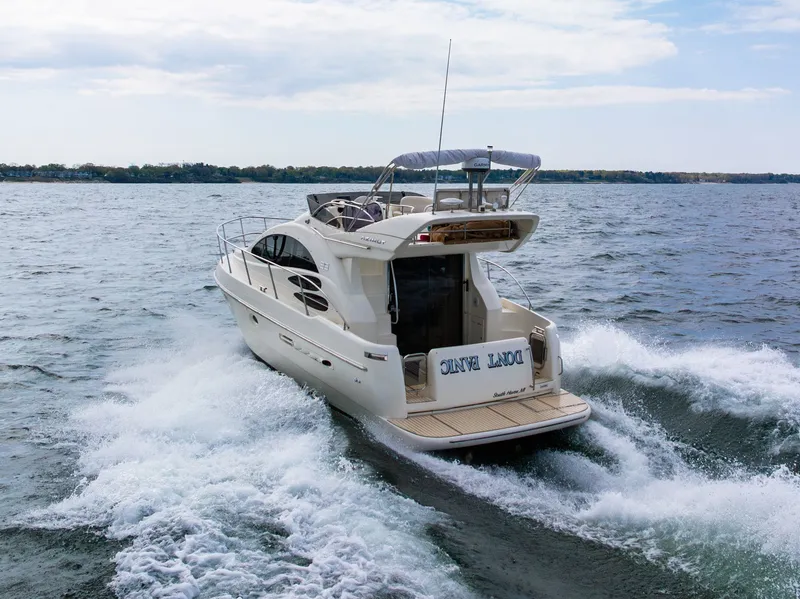 Slide: The Image of 2004 Azimut 39 Flybridge yacht cruising near city skyline. - 13