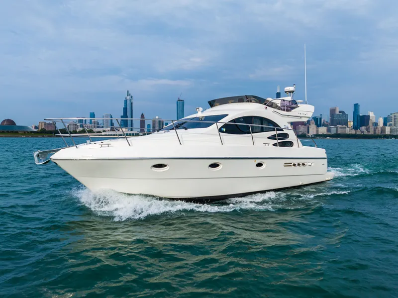 Slide: The Image of Azimut 39 Flybridge 2004 yacht on open water with city skyline. - 17