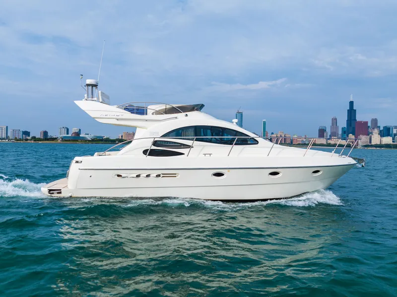 Slide: The Image of Azimut 39 Flybridge 2004 on open water with city skyline. - 24