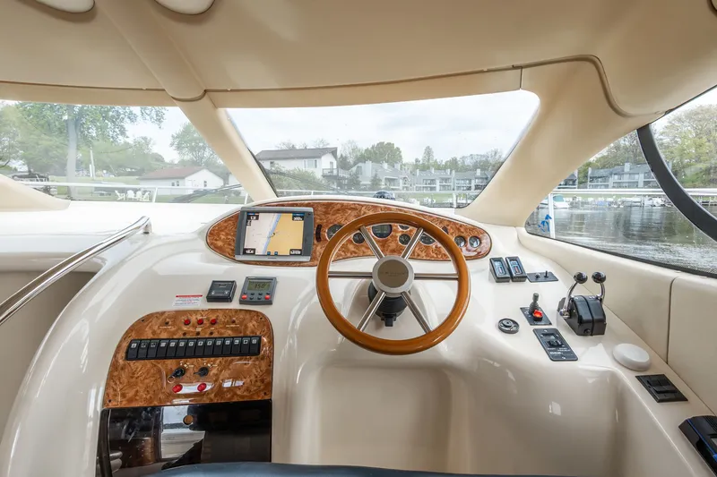 Slide: The Image of Interior view of 2004 Azimut 39 Flybridge cockpit with controls. - 36