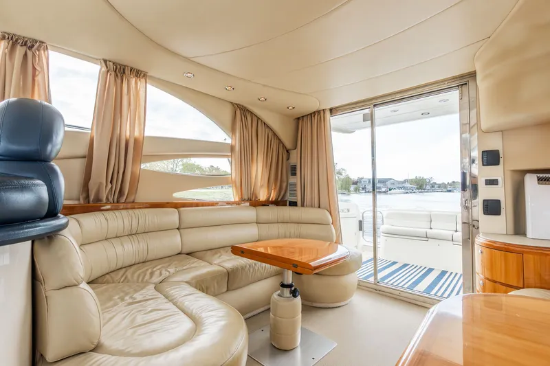 Slide: The Image of Interior of 2004 Azimut 39 Flybridge yacht with leather sofa and wooden table. - 44