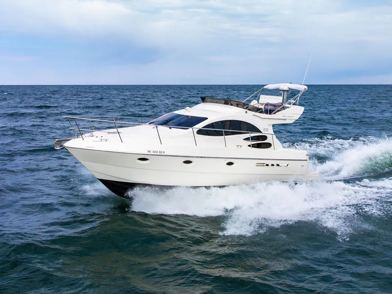 Slide: The Image of Azimut 39 Flybridge 2004 yacht cruising on water with city skyline. - 8