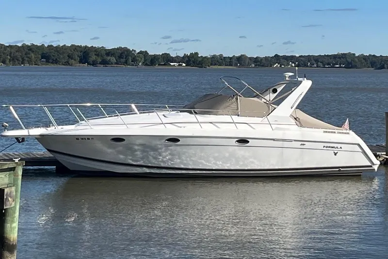 The Image of 2000 Formula 34 Performance Cruiser docked on a calm lake. - 0