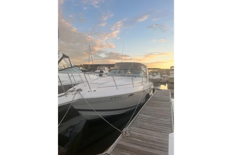 Slide: The Image of 2000 Formula 34 Performance Cruiser docked at sunset, with a scenic marina backdrop. - 2