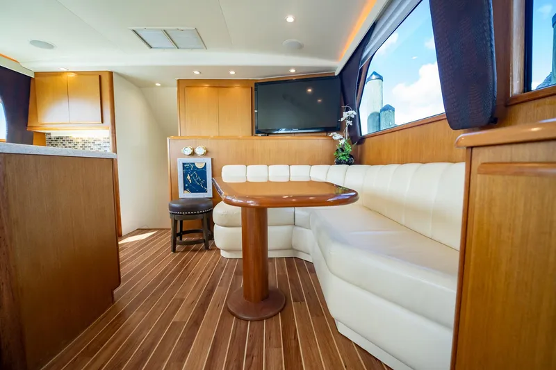 Slide: The Image of Luxurious interior of 2000 Viking 50 Conv Sport Fisher yacht with wood accents and plush seating. - 18