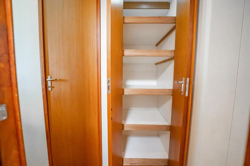 Slide: The Image of Wooden shelving inside a 2000 Viking 50 Conv Sport Fisher boat. - 30