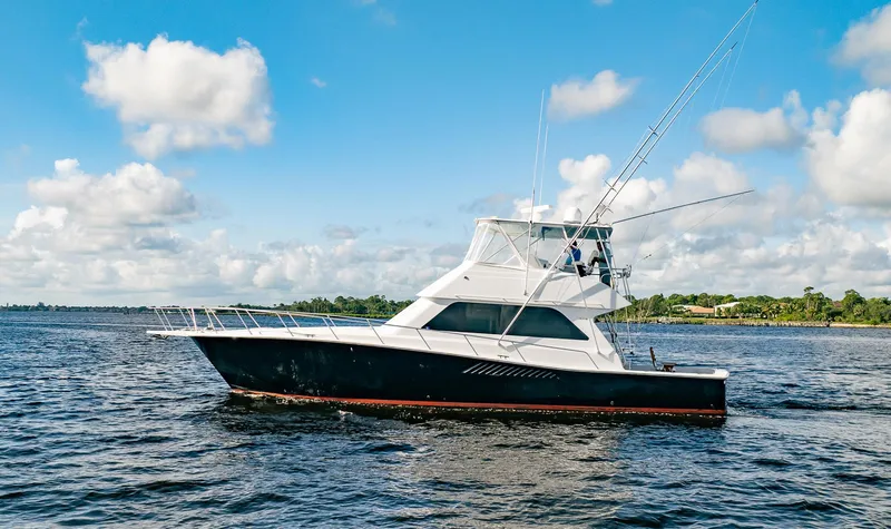 Slide: The Image of 2000 Viking 50 Conv Sport Fisher boat on open water under blue sky. - 4