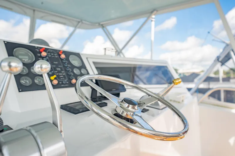 Slide: The Image of Helm of 2000 Viking 50 Conv Sport Fisher with steering wheel and control panel. - 43