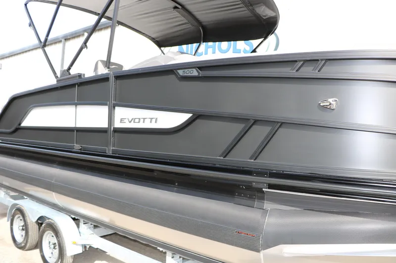 Slide: The Image of 2026 Evotti 521QL pontoon boat, sleek black design on trailer. - 61