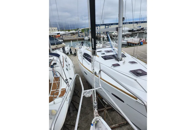 The Image of 2004 Beneteau First 36.7 sailboats docked at a marina, overcast sky. - 0