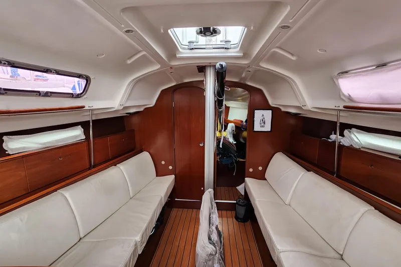 Slide: The Image of 2004 Beneteau First 36.7 yacht interior with white seating and wooden accents. - 13