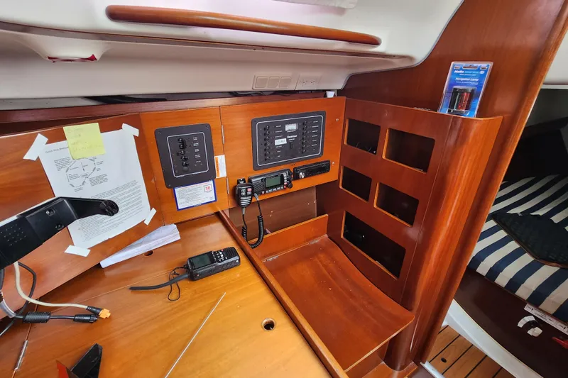 Slide: The Image of Navigation station of 2004 Beneteau First 36.7 yacht with control panels and communication equipment. - 16