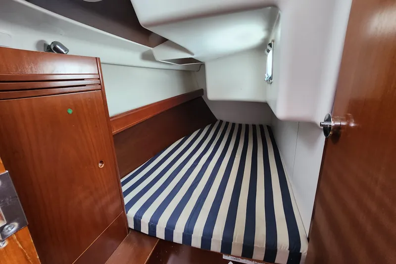 Slide: The Image of Cozy cabin interior of 2004 Beneteau First 36.7 with striped bedding. - 18