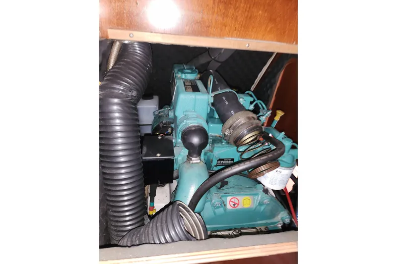 Slide: The Image of Engine compartment of a 2004 Beneteau First 36.7 sailboat, featuring a Perkins engine. - 19