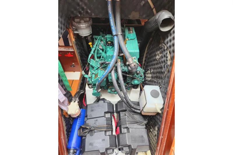 Slide: The Image of Engine compartment of a 2004 Beneteau First 36.7 sailboat, featuring a well-maintained engine. - 23