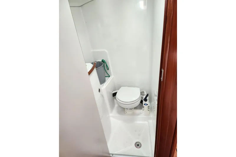 Slide: The Image of Compact bathroom in a 2004 Beneteau First 36.7 sailboat, featuring a marine toilet. - 24