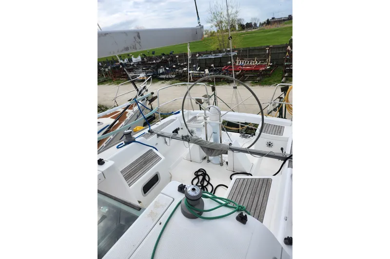 Slide: The Image of 2004 Beneteau First 36.7 sailboat cockpit with steering wheel and deck equipment. - 5