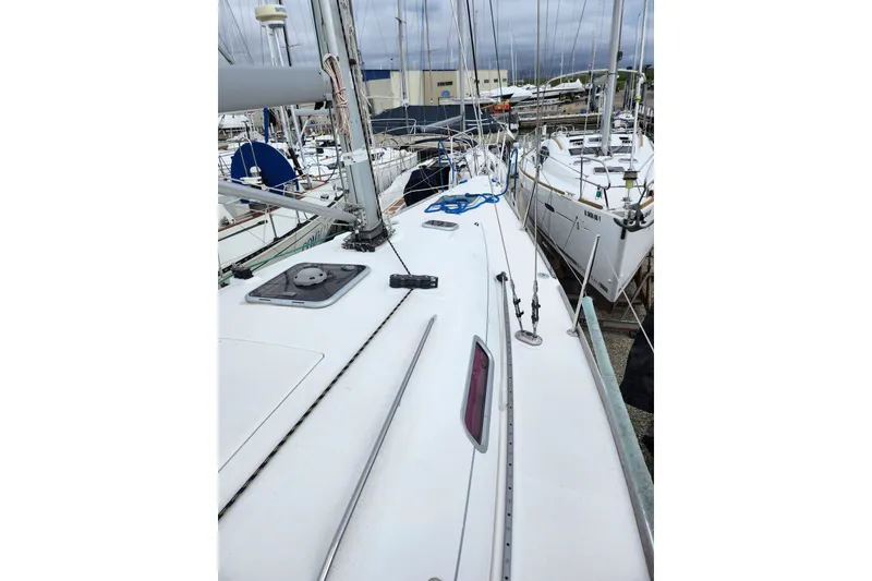 Slide: The Image of 2004 Beneteau First 36.7 sailboat docked, showcasing deck and rigging details. - 6
