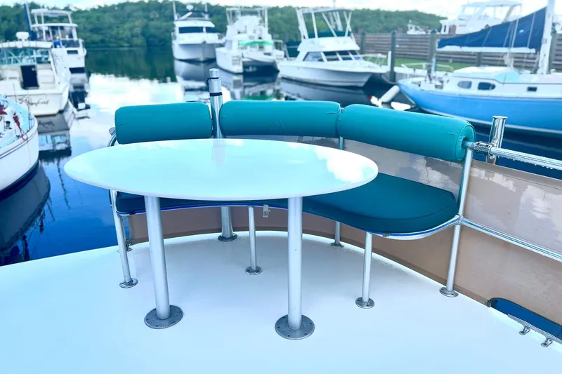 Slide: The Image of Outdoor seating area on a 2002 Custom 64 Stuart Catamarans, docked at a marina. - 12