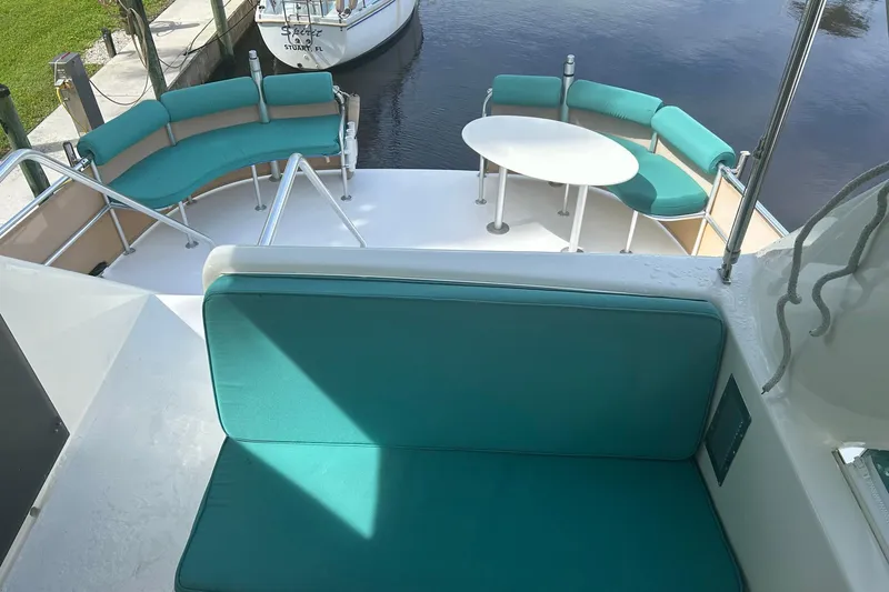 Slide: The Image of Luxurious 2002 Custom 64 Stuart Catamarans with teal seating and white table on deck. - 13