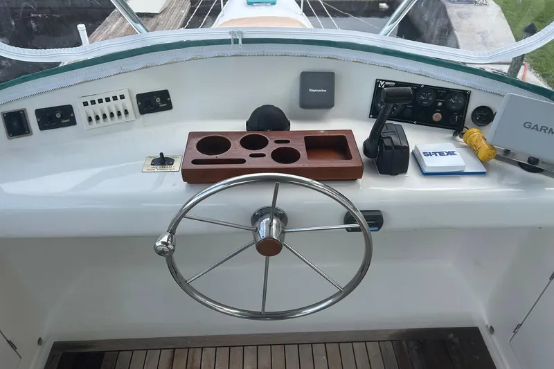Slide: The Image of Helm of 2002 Custom 64 Stuart Catamarans with steering wheel, navigation controls, and equipment. - 15