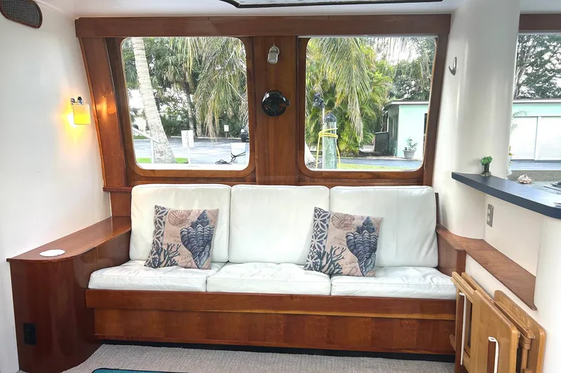 Slide: The Image of Cozy interior of 2002 Custom 64 Stuart Catamarans with white sofa and decorative pillows. - 22