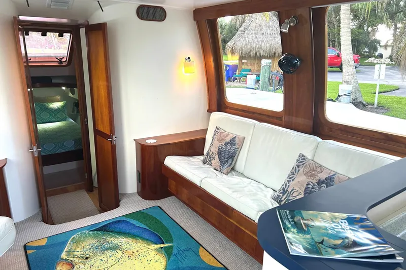 Slide: The Image of Luxurious 2002 Custom 64 Stuart Catamarans interior with cozy seating and vibrant marine-themed decor. - 23