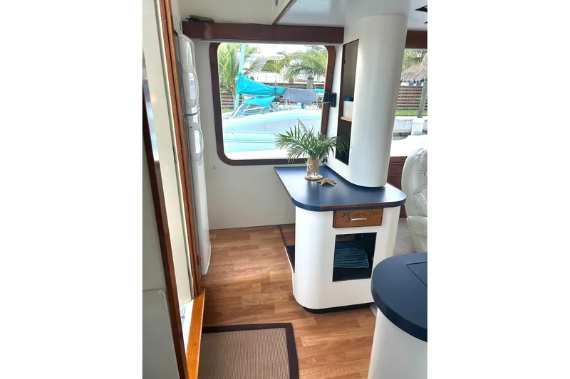 Slide: The Image of Interior of 2002 Custom 64 Stuart Catamarans with modern decor and wooden flooring. - 27