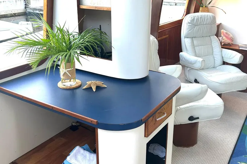 Slide: The Image of Luxurious interior of 2002 Custom 64 Stuart Catamarans with white chairs and decorative plants. - 28