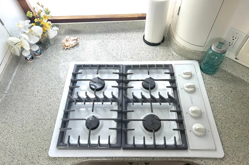 Slide: The Image of Gas stove on granite countertop in a 2002 Custom 64 Stuart Catamarans kitchen. - 31