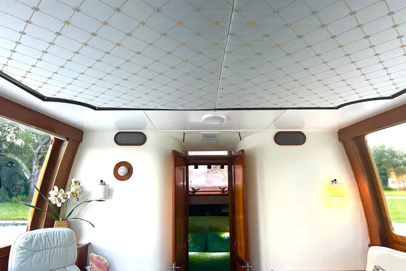 Slide: The Image of Interior of 2002 Custom 64 Stuart Catamarans with elegant ceiling and cozy seating area. - 34
