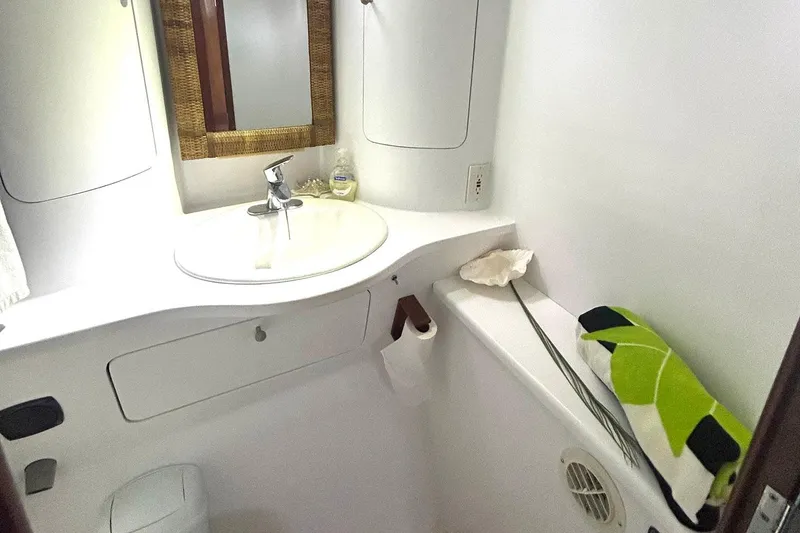 Slide: The Image of Bathroom interior of 2002 Custom 64 Stuart Catamarans with sink, mirror, and towel. - 36